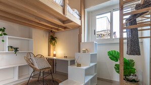 A modern, well-lit room with a bunk bed, a desk with a chair, and shelves. - Viola Penthouse with Rome Panoramic View (ROMA)