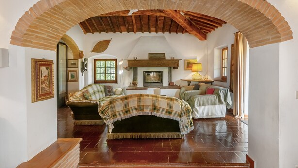 An arched brick ceiling, a fireplace, a sofa, and a bed in a room with wooden flooring. - Agriturismo 'Molinuzzo - Lisa' with Shared Pool, Private Terrace and Wi-Fi (Barberino Tavarnelle)