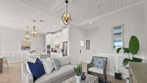A modern living room with a sofa, coffee table, and decorative lighting. - Breezeway: Luxury Listing- Largest Private Pool, mini-GOLF, Sunset  & Bay view (Galveston)