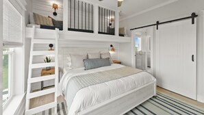 A bedroom with a bunk bed, a ceiling fan, a bedside table with a lamp, and a large window. - Breezeway: Luxury Listing- Largest Private Pool, mini-GOLF, Sunset  & Bay view (Galveston)
