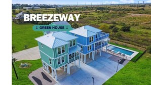 A green house with a pool and a tennis court. - Breezeway: Luxury Listing- Largest Private Pool, mini-GOLF, Sunset  & Bay view (Galveston)