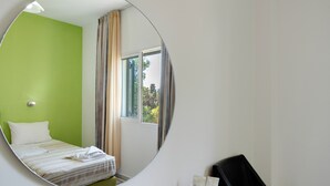 A hotel room with a bed, a mirror, a chair, and a window with curtains. - Bed and Breakfast 'Ilios and Irene  6' with Shared Terrace, Wi-Fi and Air Conditioning (?ast??a??)
