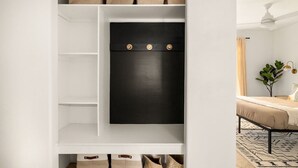 A white storage unit with multiple shelves and a black panel with three round knobs. - Modern Desert Escape - Fire Pit, BBQ and Design (Yucca Valley)