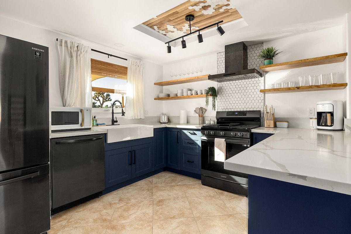 A modern kitchen with a built-in oven, microwave, and refrigerator.