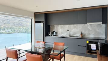 Deluxe Suite, Balcony, Lake View | Private kitchen | Full-size fridge, microwave, oven, stovetop