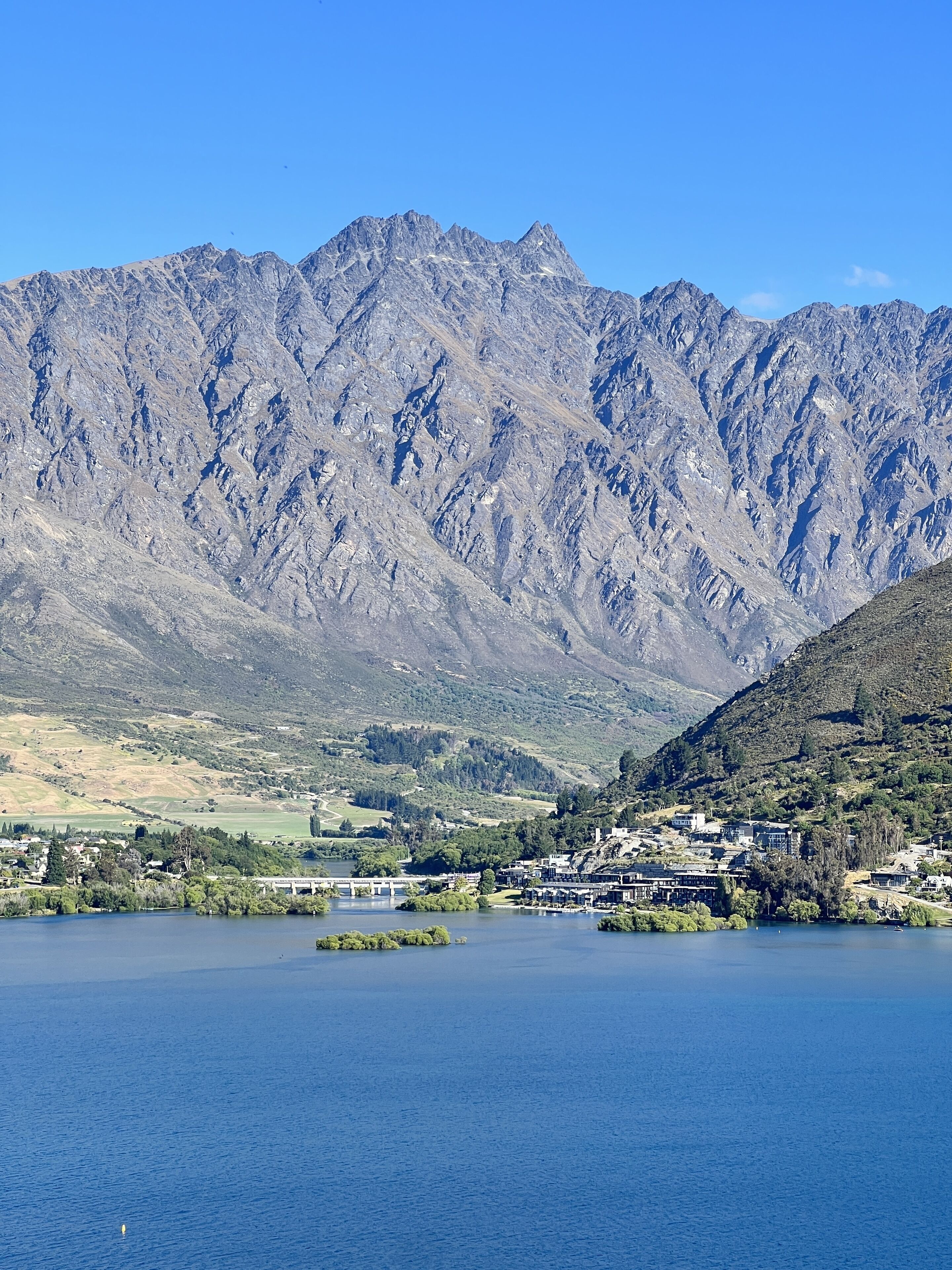 A mountainous landscape with a lake and a small island.