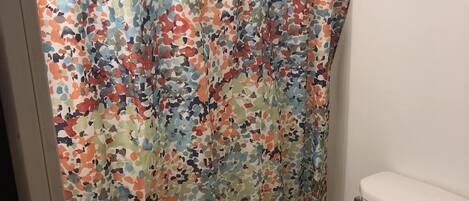 Combined shower/bathtub, towels, toilet paper