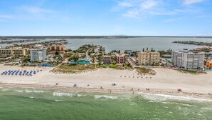 A coastal hotel area with beachfront access, multiple buildings, and a clear view of the sea.