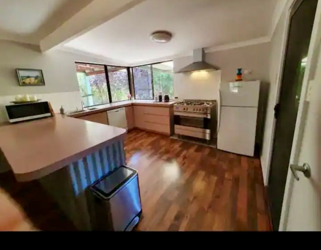 A fully equipped kitchen with a coffee machine and dishwasher.
