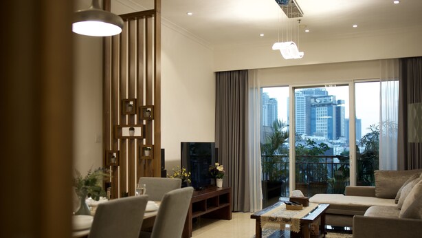 A modern living room with a sofa, TV, and dining area. - Great location - 2BR Apartment in Senayan, Jakarta (Daerah Khusus Ibukota Jakarta)