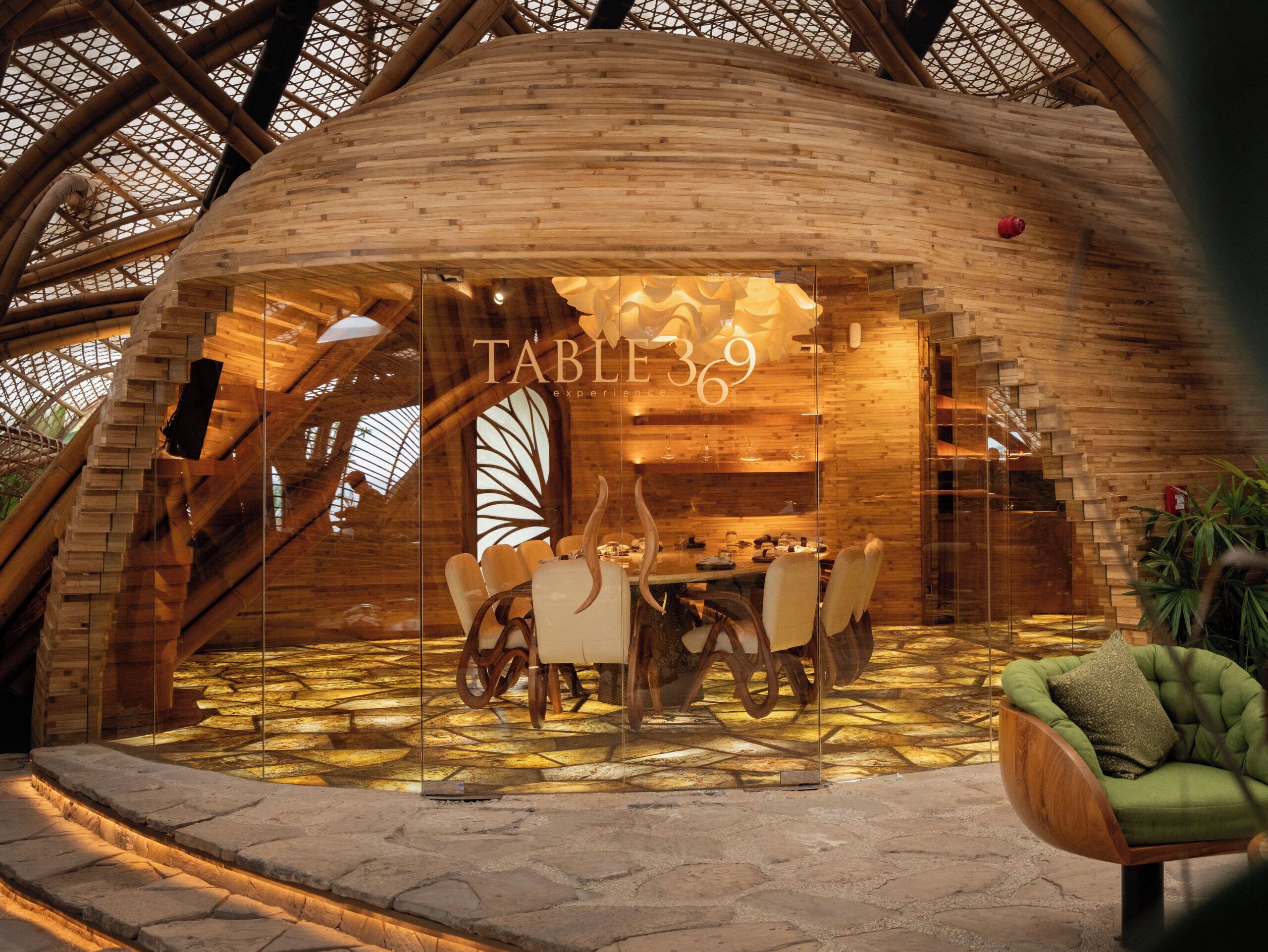 A restaurant with a wooden interior and a glass wall.