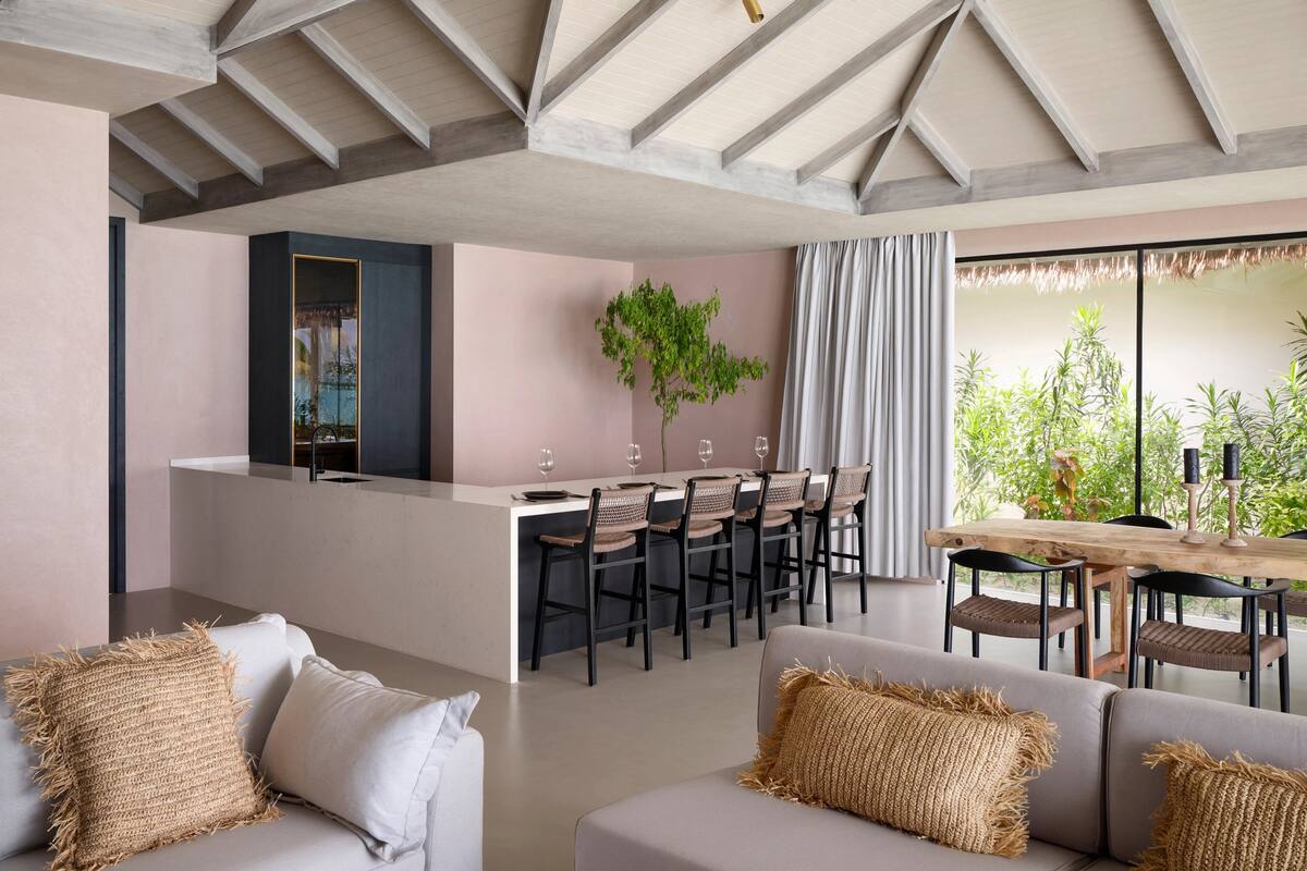 A modern interior with a dining area, bar, and seating.