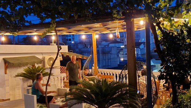 An outdoor patio area with seating and a pergola. - The perfect one bedroom apartment (Sarande)