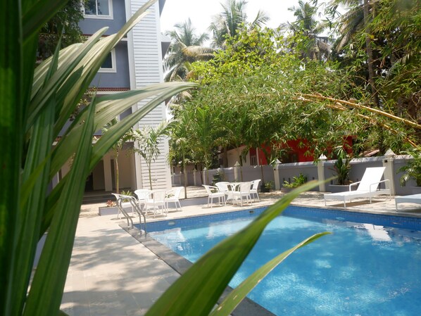 Outdoor pool, open 7:00 AM to 7:00 PM, pool umbrellas, pool loungers