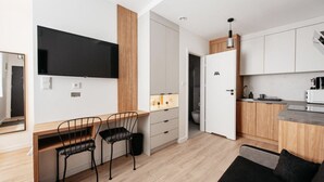 A modern kitchen with white cabinets, a wooden countertop, and a built-in oven. - Berka Joselewicza 12/30 (Kraków)
