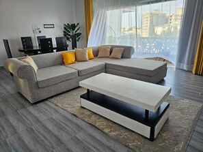 Family Apartment | Living area | 24-inch Smart TV with digital channels - Lux Suites Siloam Holiday Apartments (Mombasa)