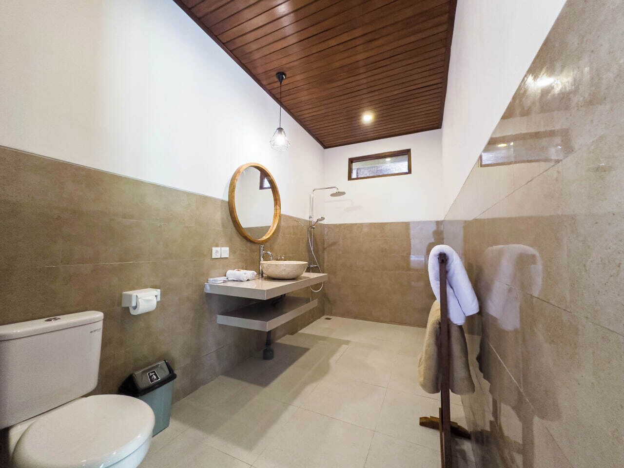 A bathroom with a toilet, sink, and shower.
