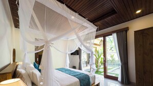 A bedroom with a canopy bed, a bedside table, and a view of the outdoors. - Tutik Private House by Supala (Ubud)