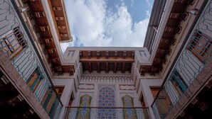 A multi-level building with ornate balconies and intricate tile work. - Asal Boutique Hotel (Bukhara)