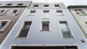 A multi-story building with numbered windows and doors, indicating individual apartments or units.