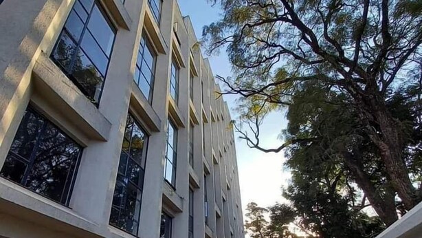 A modern building with multiple windows and a paved walkway. - Lux Suites Mattlet Studio Apartments TRM (Nairobi)