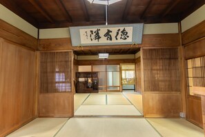 Experience traditional Japanese charm in this serene room with tatami flooring and sliding door.