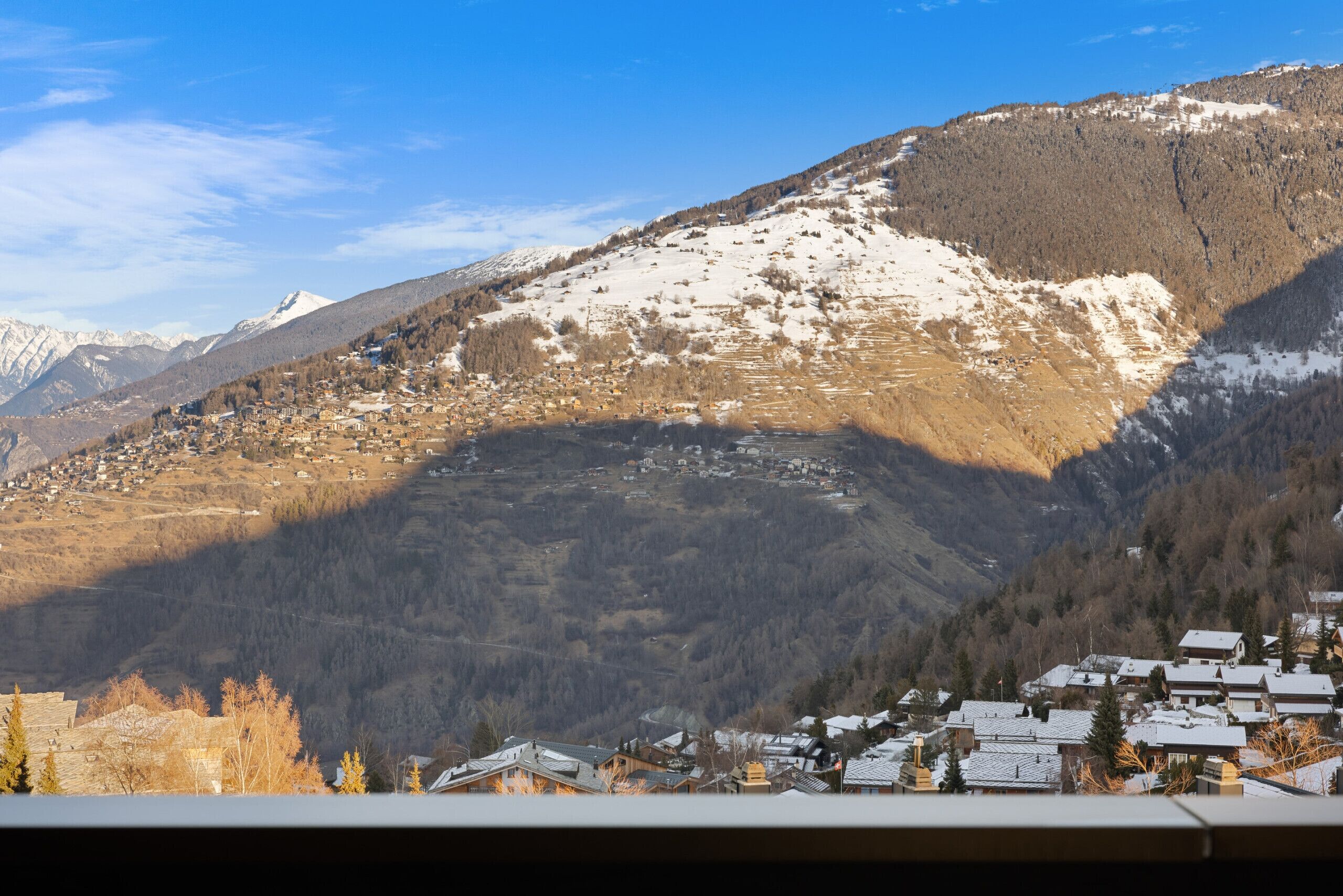 A mountainous landscape with a village nestled in the valley.