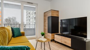Een moderne woonkamer met een bank, een salontafel, een televisie en een kast.