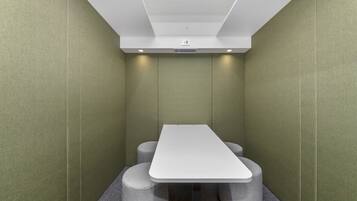 Simple, modern space with a single table and four stools.
