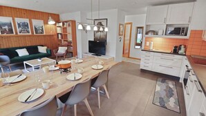 A modern kitchen with white cabinets, a microwave, and a coffee maker.