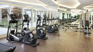 A modern gym with treadmills, ellipticals, and weight machines. - Premium Studio near Butterfly Garden w/ Pool & Gym (Dubai)