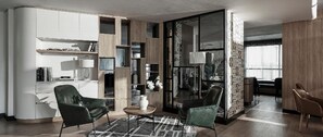 A modern living room with a sofa, chairs, a coffee table, and a bookshelf. - Zenity Luxury Vacation Ho Chi Minh City (Ho Chi Minh City)