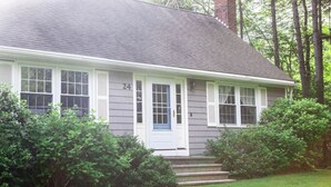 A single-story house with a gray exterior, white trim, and a blue door. - The Coastal Cottage | Walk to Pemaquid Beach | Fire Pit & Family-Friendly Retreat (Bristol)