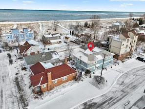 A residential area with houses, a beach, and a red circular object. - 2 BD Condo I Steps From Lake Mich (Michigan City)