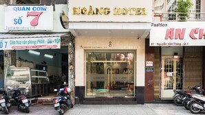 A hotel with a sign reading "Hoang Hotel" and a visible entrance. - Hoang Luxury Hotel Dist 1 Ho Chi Minh (Ho Chi Minh City)