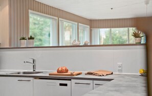 A modern kitchen with a built-in dishwasher, a stainless steel sink, and a wooden countertop. - 3 bedroom pet friendly home in Højslev (Højslev)