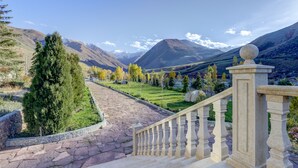 A stone staircase leading to a scenic view of mountains and a clear sky. - Mountain View Hot Spring Resort (Koy-Tash)