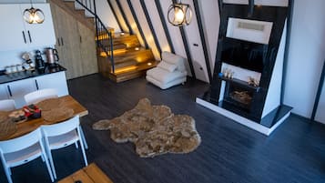Habitación de lujo | Área de sala de estar | Smart TV de 82 pulgadas con canales por cable y chimenea