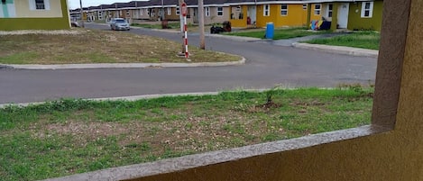 A residential area with houses, a stop sign, and utility poles.