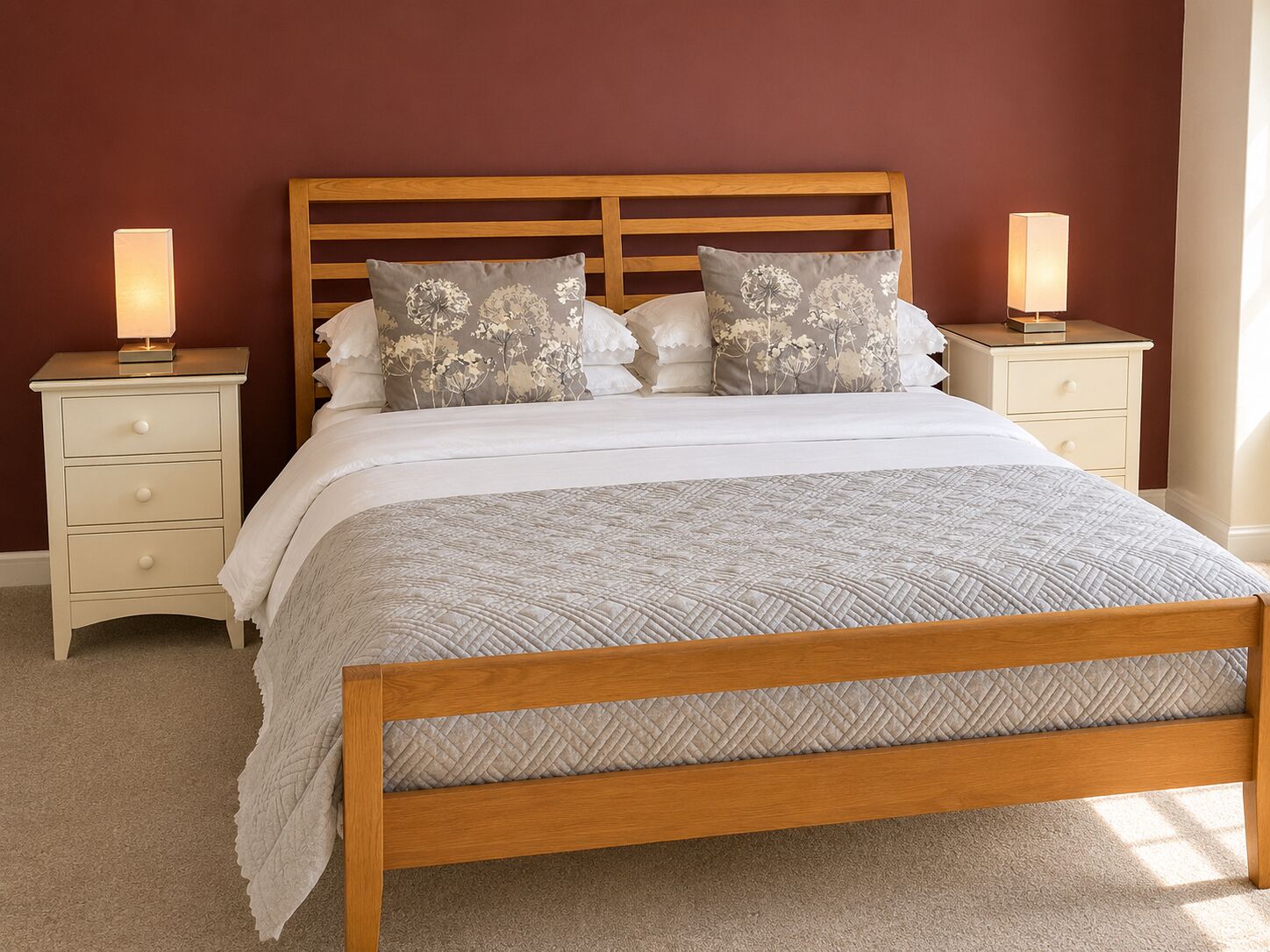 A bedroom with a wooden bed, two bedside tables, and a nightstand.