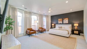 A modern hotel room with a large bed, two armchairs, a small table, and a large window. - Best of Midtown-3 Bedrooms, Minutes to Attractions (Houston)
