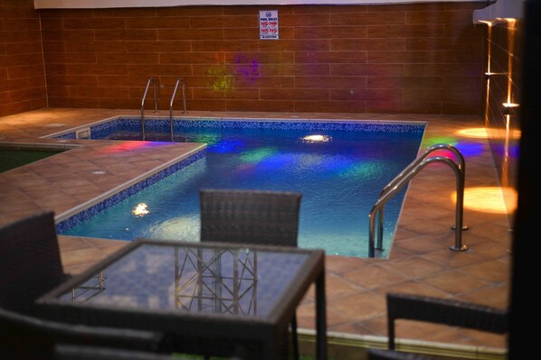 An indoor swimming pool with tiled walls and a sign prohibiting diving. - Mapleviewhotels and Suite Limited (Lekki)