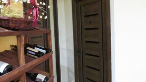 A wine rack with bottles and a basket with flowers.