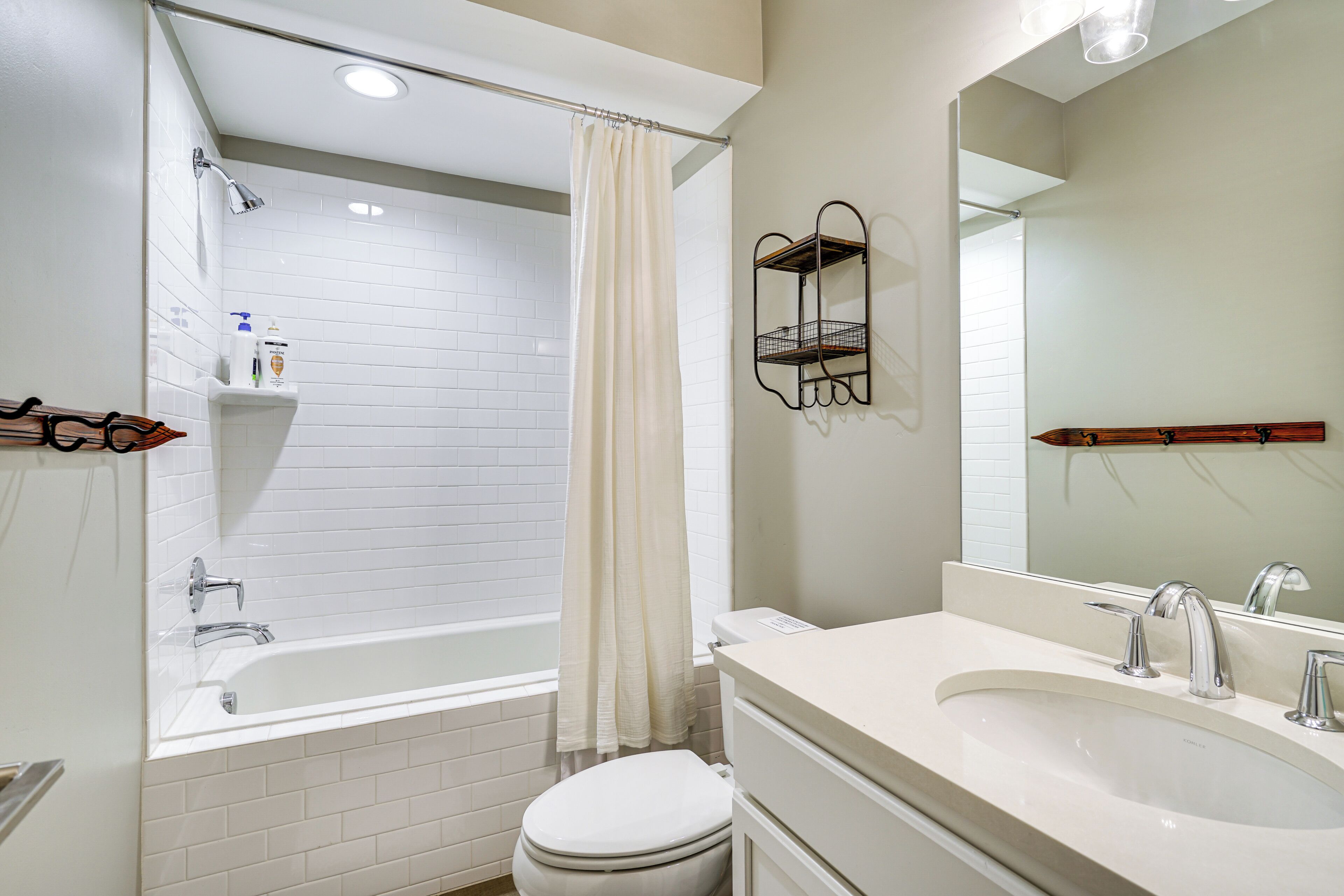 A modern bathroom with a bathtub, toilet, and sink.