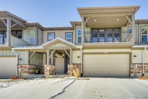 A two-story residential building with a garage, a covered porch, and a brick facade. - Francis Townhome: 5 Mi to Park City Mountain! (Heber City)