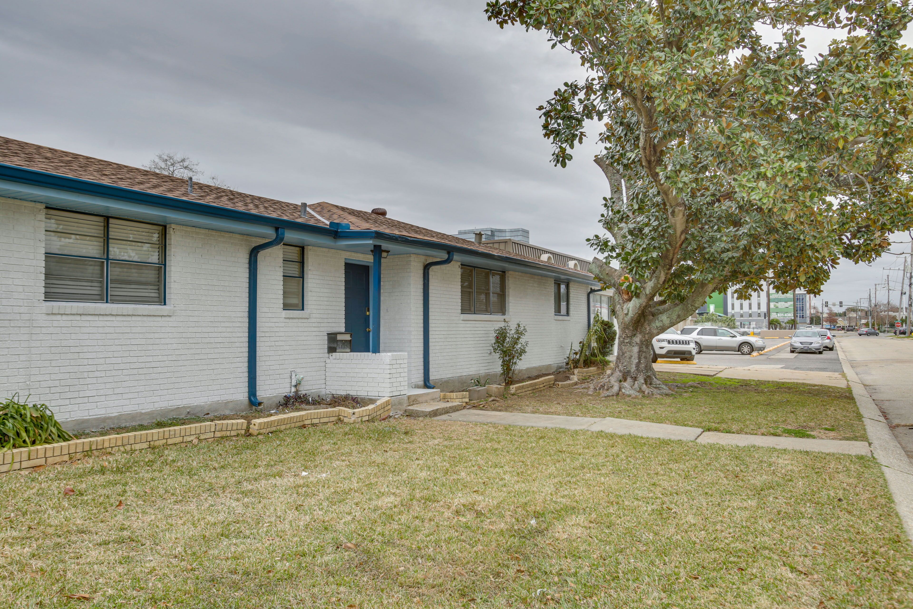 A single-story house with a front yard, a tree, and a driveway.