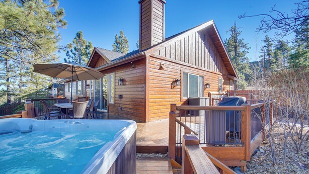 A wooden cabin with a hot tub, outdoor seating, and a deck. - Big Bear Lake Cabin w/ Hot Tub & Gas Fire Pit! (Big Bear Lake)