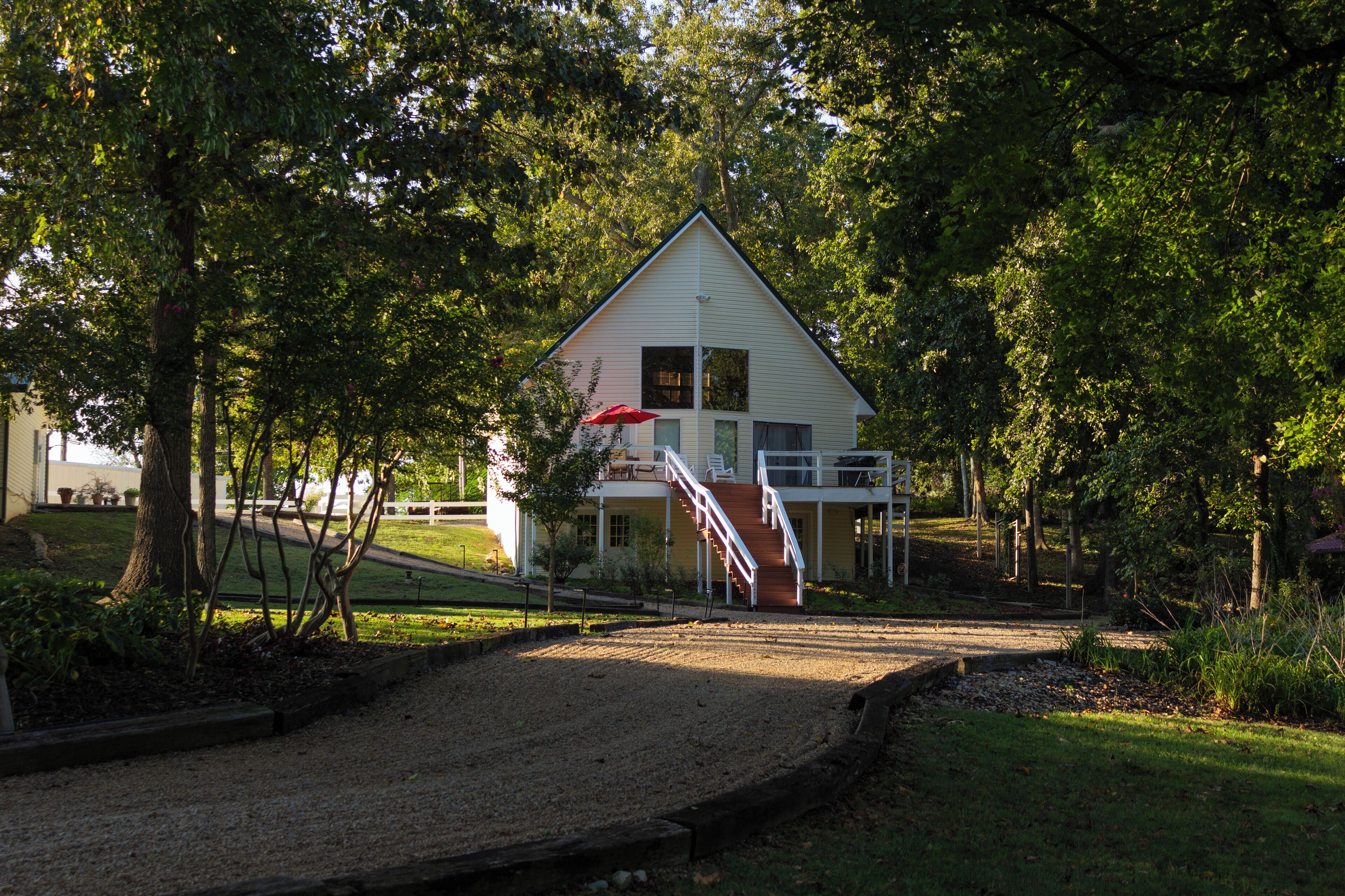 A two-story house with a covered porch and a staircase leading to the upper floor.