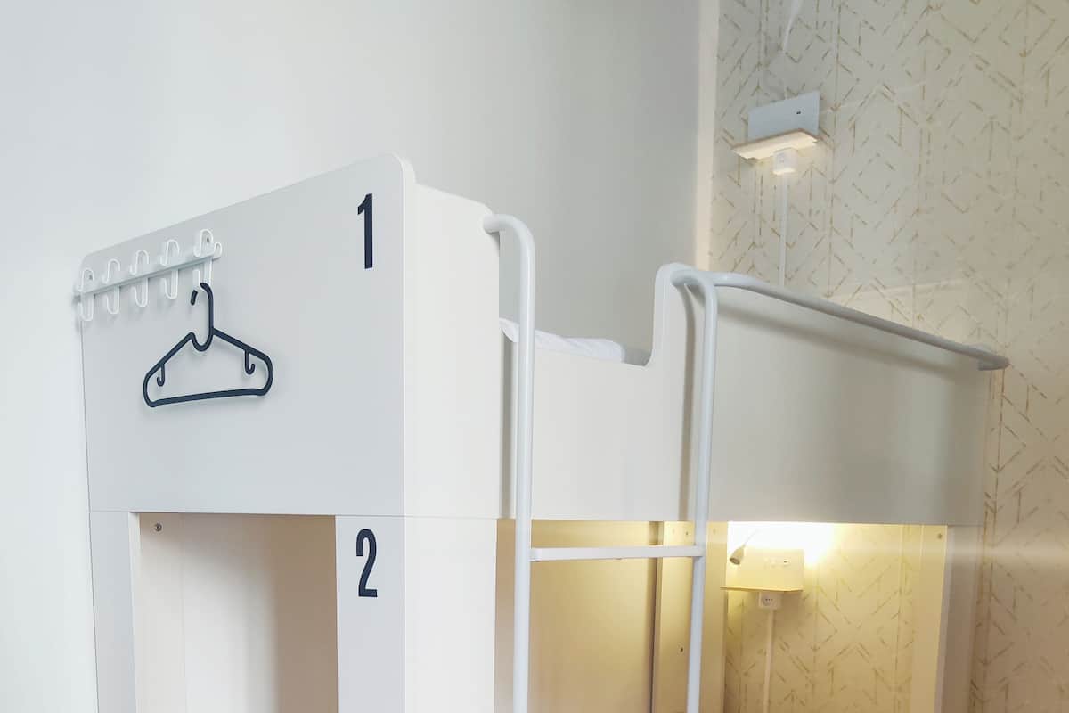A bunk bed with two levels, each marked with a number.