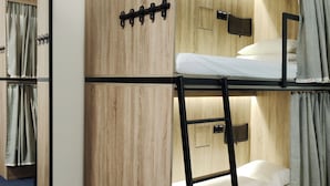 A bunk bed room with wooden walls, a small shelf, and a mirror. - VIKI Kazimierz (Kraków)